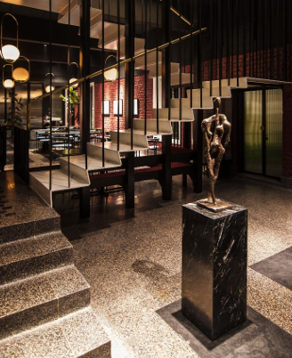 Thirsty City  Restaurant in Mumbai Folded staircase, Brass Railing, Brass and Copper  cast Art motif, Art deco windows in cast iron.
